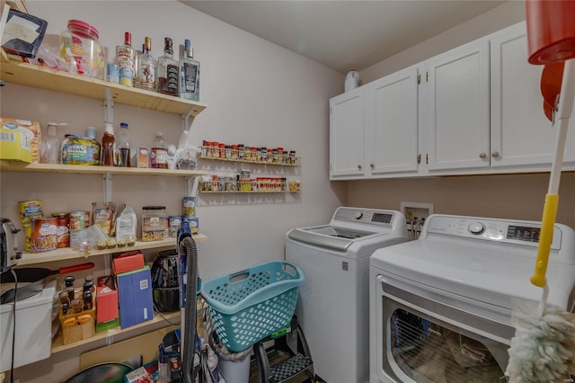 laundry room with cabinets and washer and dryer