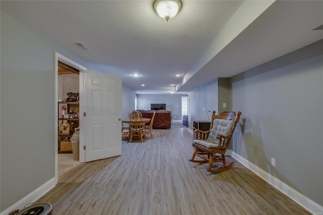 living area with light hardwood / wood-style flooring