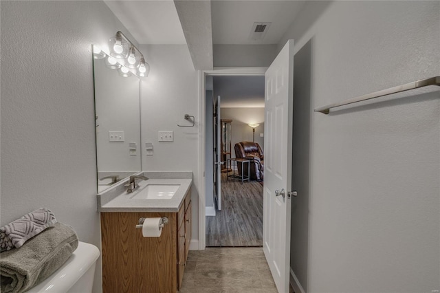 bathroom with vanity and toilet