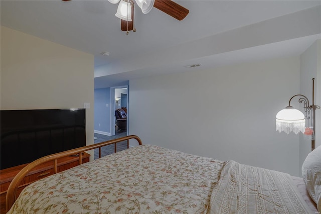 bedroom featuring ceiling fan and a walk in closet