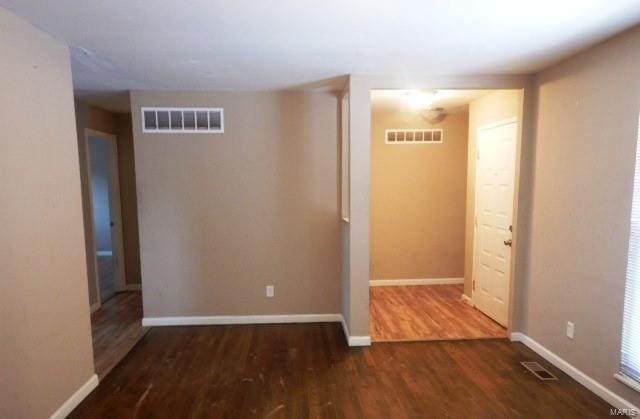 unfurnished room featuring dark wood-type flooring