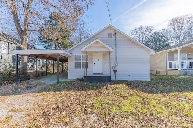 bungalow with a carport and a front lawn