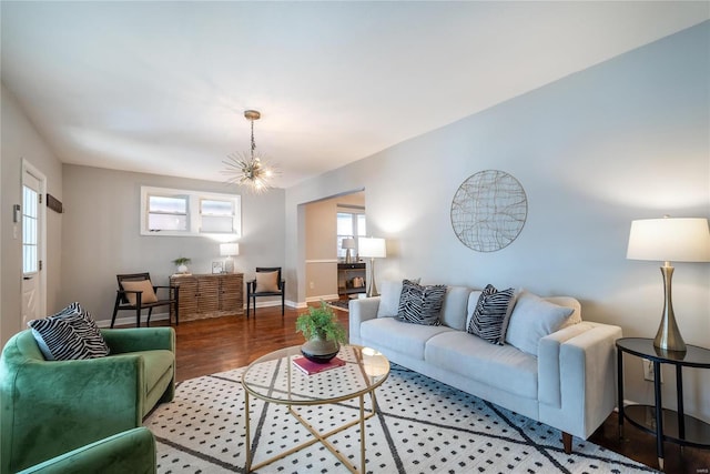 living room featuring an inviting chandelier and hardwood / wood-style floors