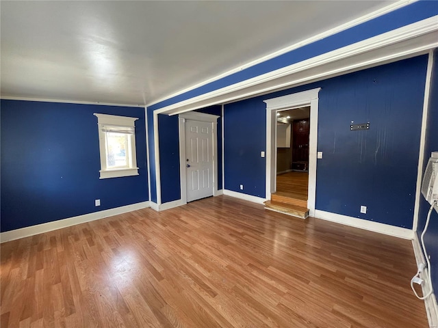 unfurnished bedroom with hardwood / wood-style floors, a closet, and ornamental molding