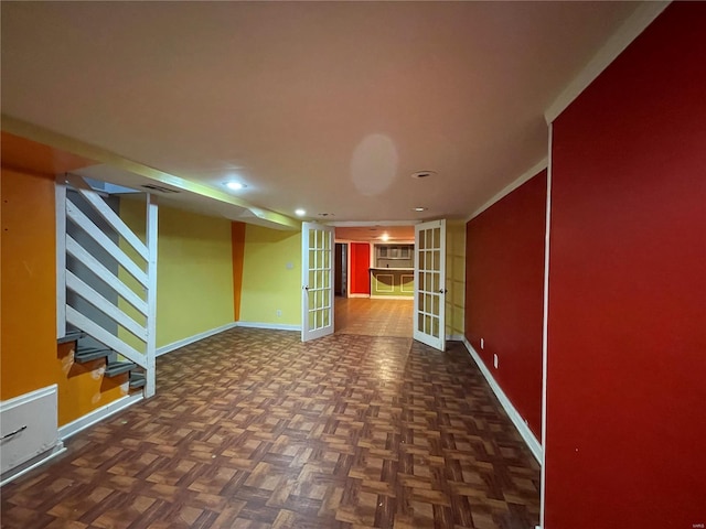 basement with dark parquet floors and french doors