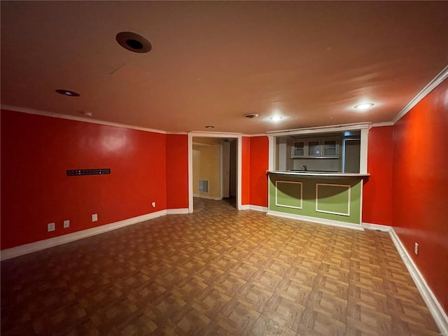 spare room with parquet flooring and ornamental molding