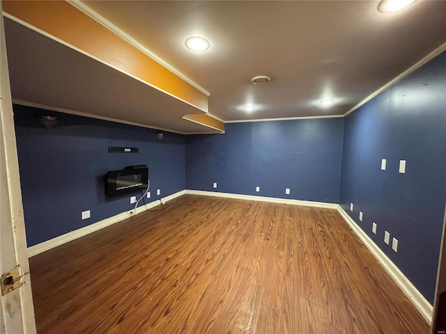 basement with ornamental molding and wood-type flooring