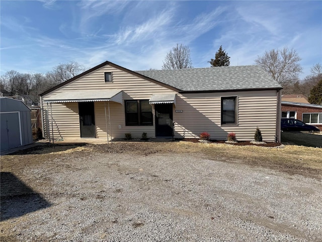 view of front of home with a shed