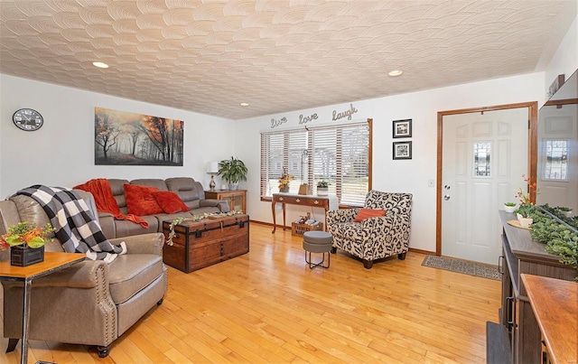 living room with light hardwood / wood-style floors and a textured ceiling