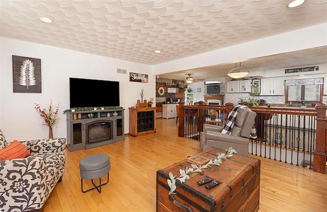 living room featuring hardwood / wood-style flooring and a fireplace