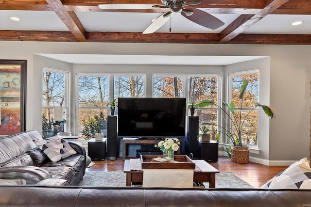 living room with hardwood / wood-style flooring, a healthy amount of sunlight, coffered ceiling, and beam ceiling