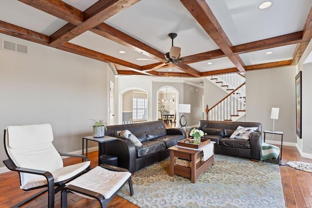 living room with coffered ceiling, beam ceiling, light hardwood / wood-style flooring, and ceiling fan