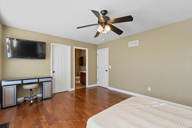 bedroom featuring dark wood-type flooring, connected bathroom, and ceiling fan