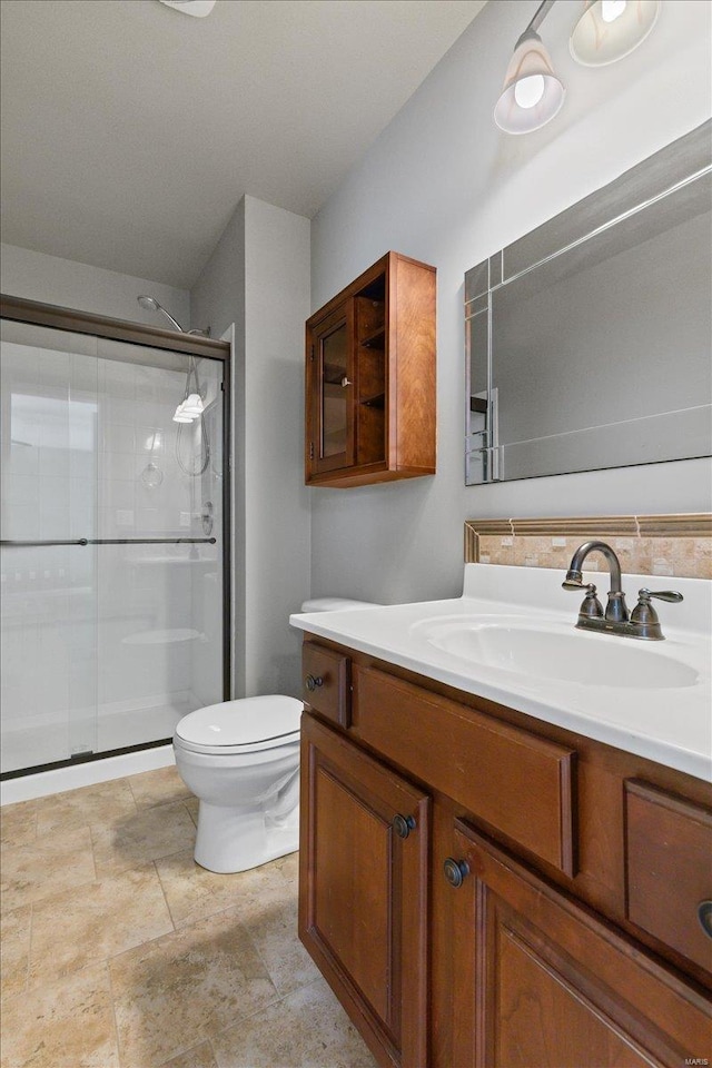 bathroom featuring walk in shower, vanity, and toilet