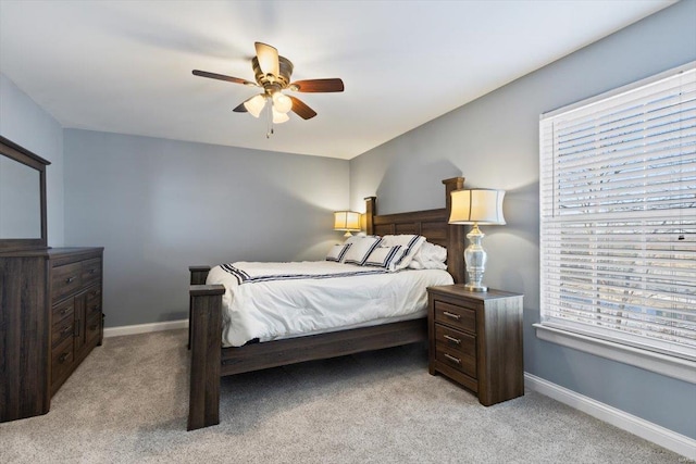 bedroom featuring light carpet and ceiling fan