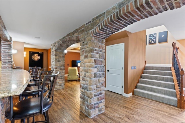 interior space with wood-type flooring and decorative columns