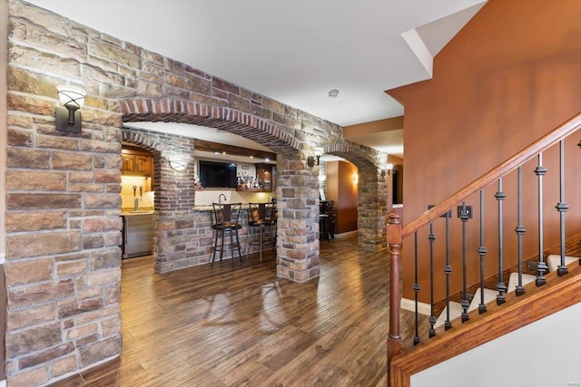 bar featuring dark wood-type flooring