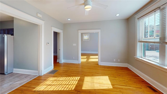 unfurnished room featuring ceiling fan and light hardwood / wood-style flooring