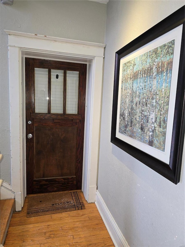 doorway with light wood-type flooring