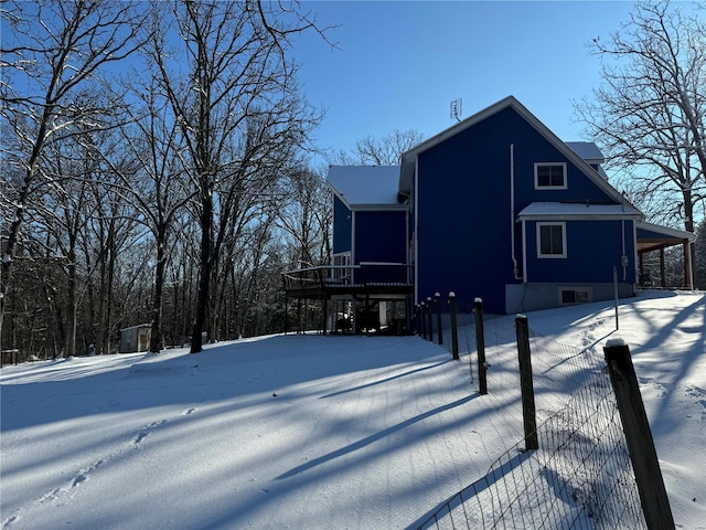 view of snow covered rear of property