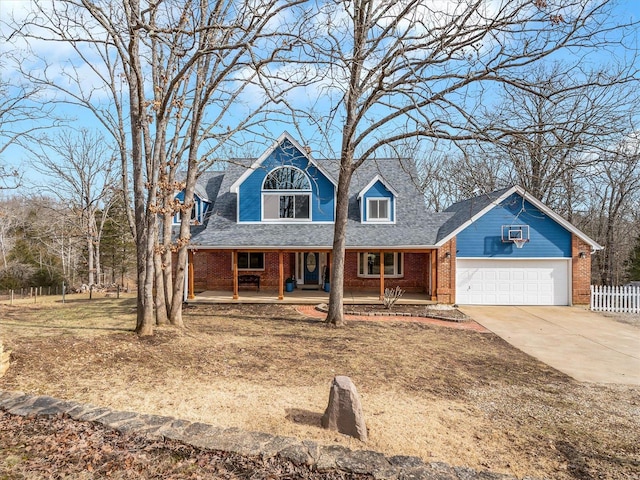 cape cod house with a porch and a garage