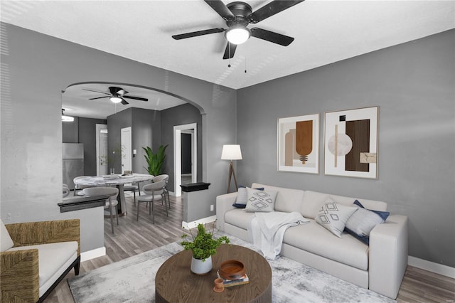 living room with hardwood / wood-style flooring, a textured ceiling, and ceiling fan