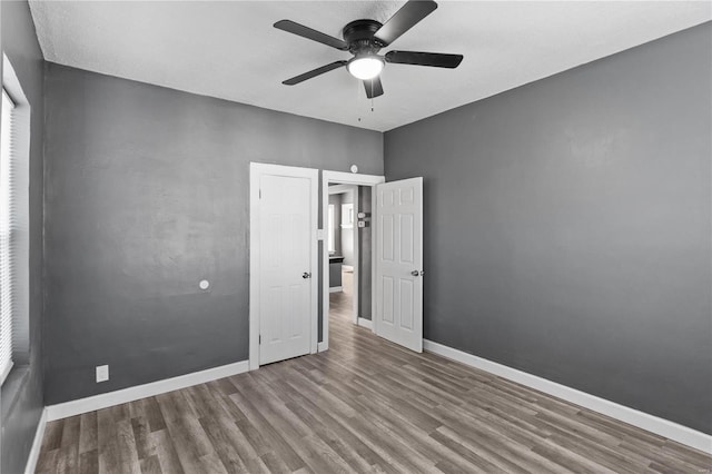 unfurnished bedroom with hardwood / wood-style flooring and ceiling fan