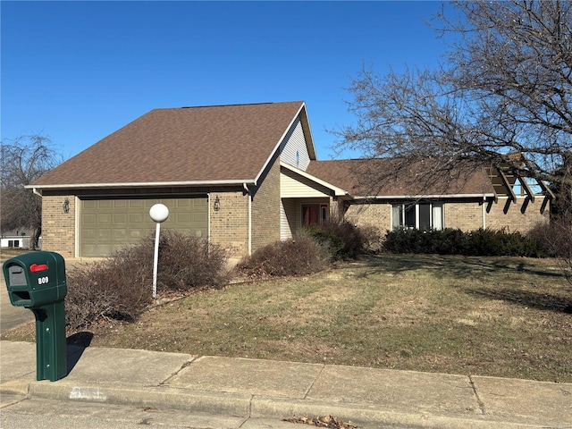 exterior space featuring a garage and a lawn