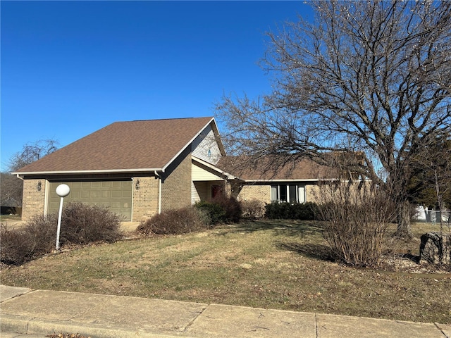 view of side of property featuring a garage and a yard