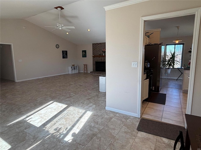 unfurnished living room with ceiling fan, lofted ceiling, light tile patterned floors, and a fireplace