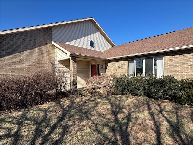 view of property exterior with a lawn