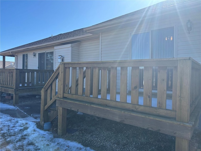 snow covered house with a deck