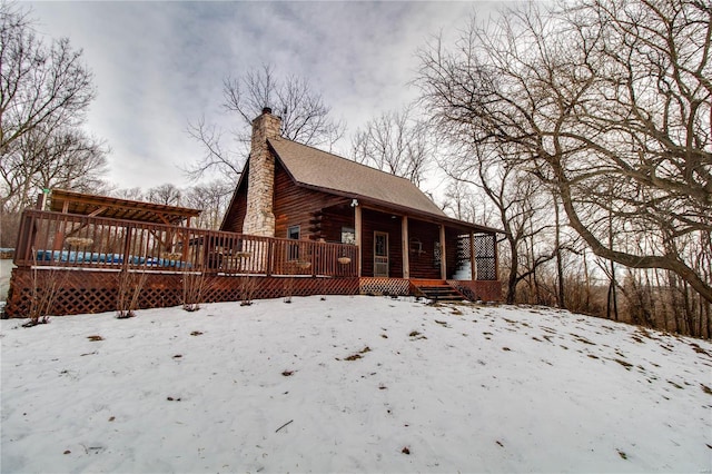 snow covered property featuring a porch