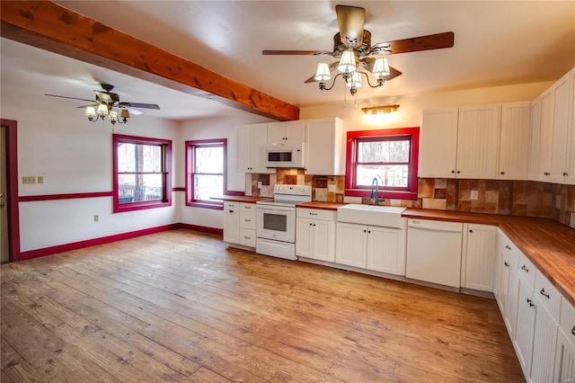 kitchen with white cabinetry, sink, and white appliances