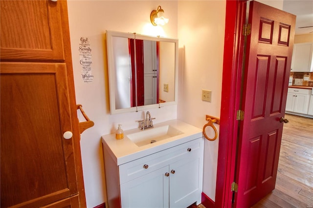 bathroom featuring hardwood / wood-style flooring and vanity