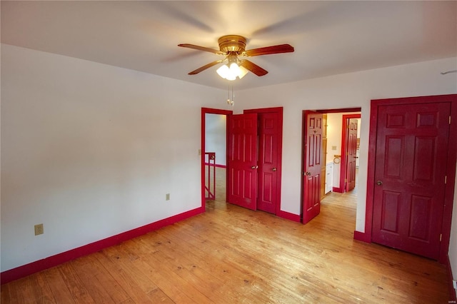 unfurnished bedroom with ceiling fan and light hardwood / wood-style flooring