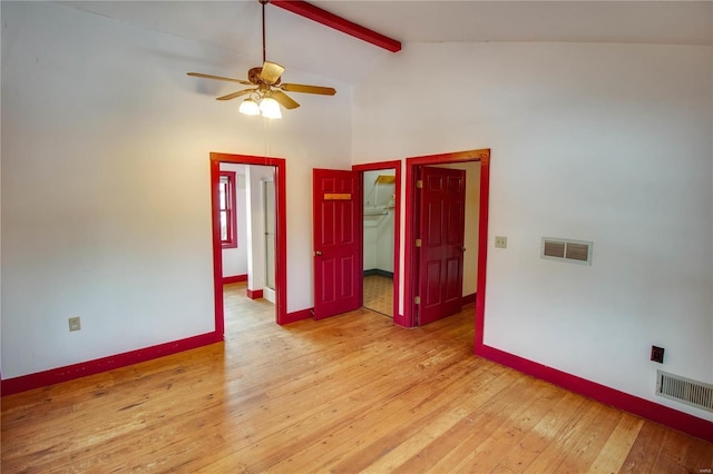 spare room featuring ceiling fan, beamed ceiling, light hardwood / wood-style flooring, and high vaulted ceiling