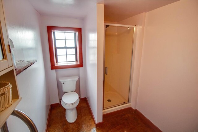 bathroom with a shower with door and toilet