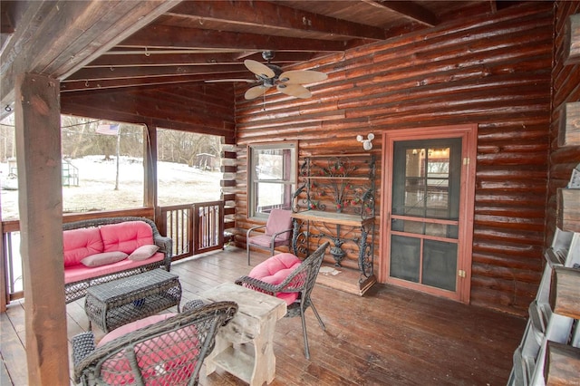 sunroom / solarium with ceiling fan, wood ceiling, and vaulted ceiling with beams