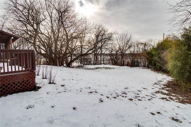 snowy yard featuring a deck