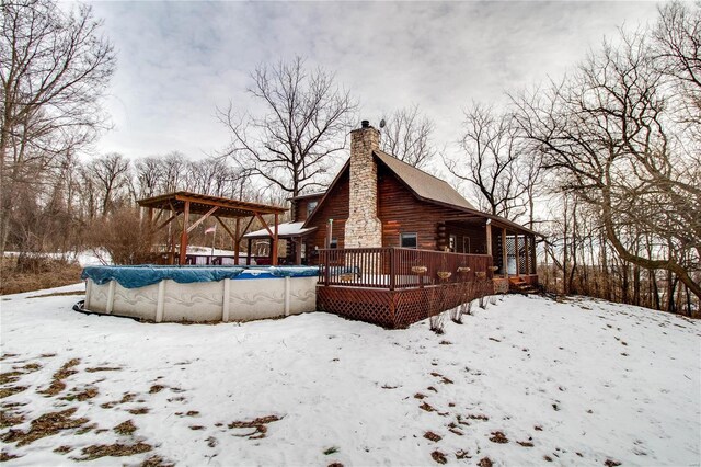 snow covered property featuring a swimming pool side deck