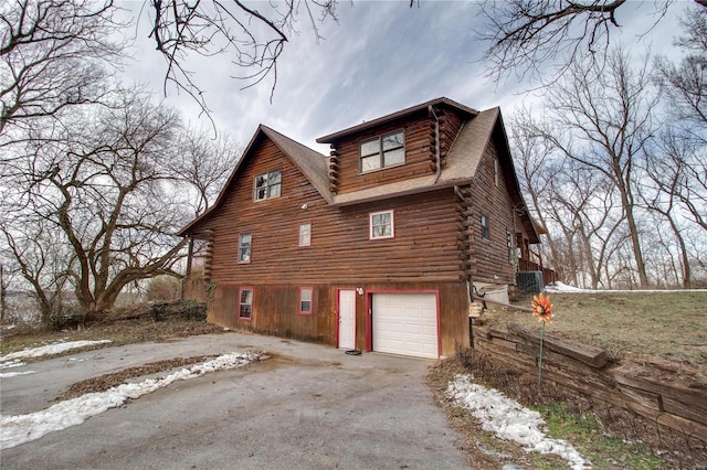 view of home's exterior with a garage and cooling unit