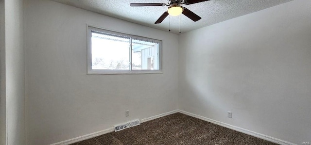 spare room featuring ceiling fan, a textured ceiling, and carpet