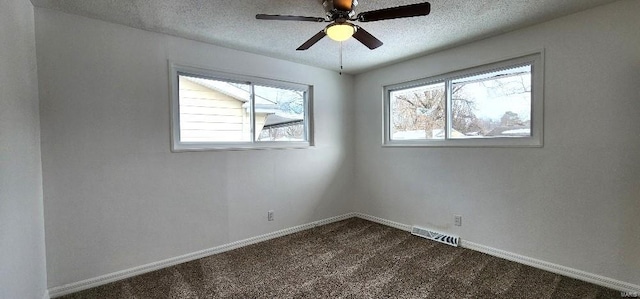 empty room featuring ceiling fan, a textured ceiling, and carpet floors