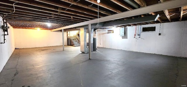 basement with electric panel and water heater