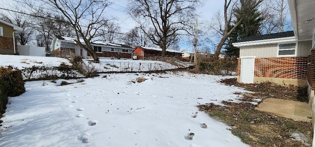 view of yard layered in snow