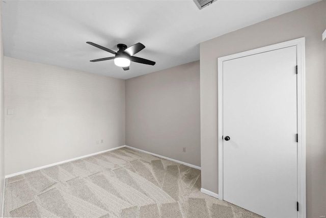 unfurnished room featuring light colored carpet and ceiling fan