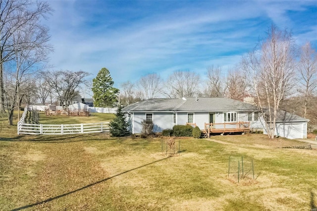 rear view of property with a deck and a lawn