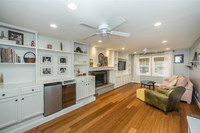 interior space featuring wine cooler, light hardwood / wood-style floors, and ceiling fan