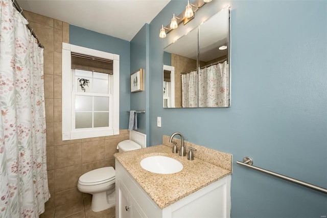 bathroom featuring tile walls, vanity, toilet, tile patterned floors, and a shower with shower curtain